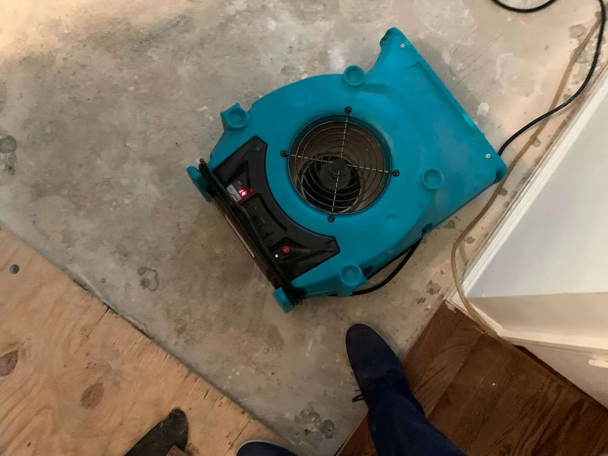 Air mover drying subfloor during Leak Detection & Repair in Aztec